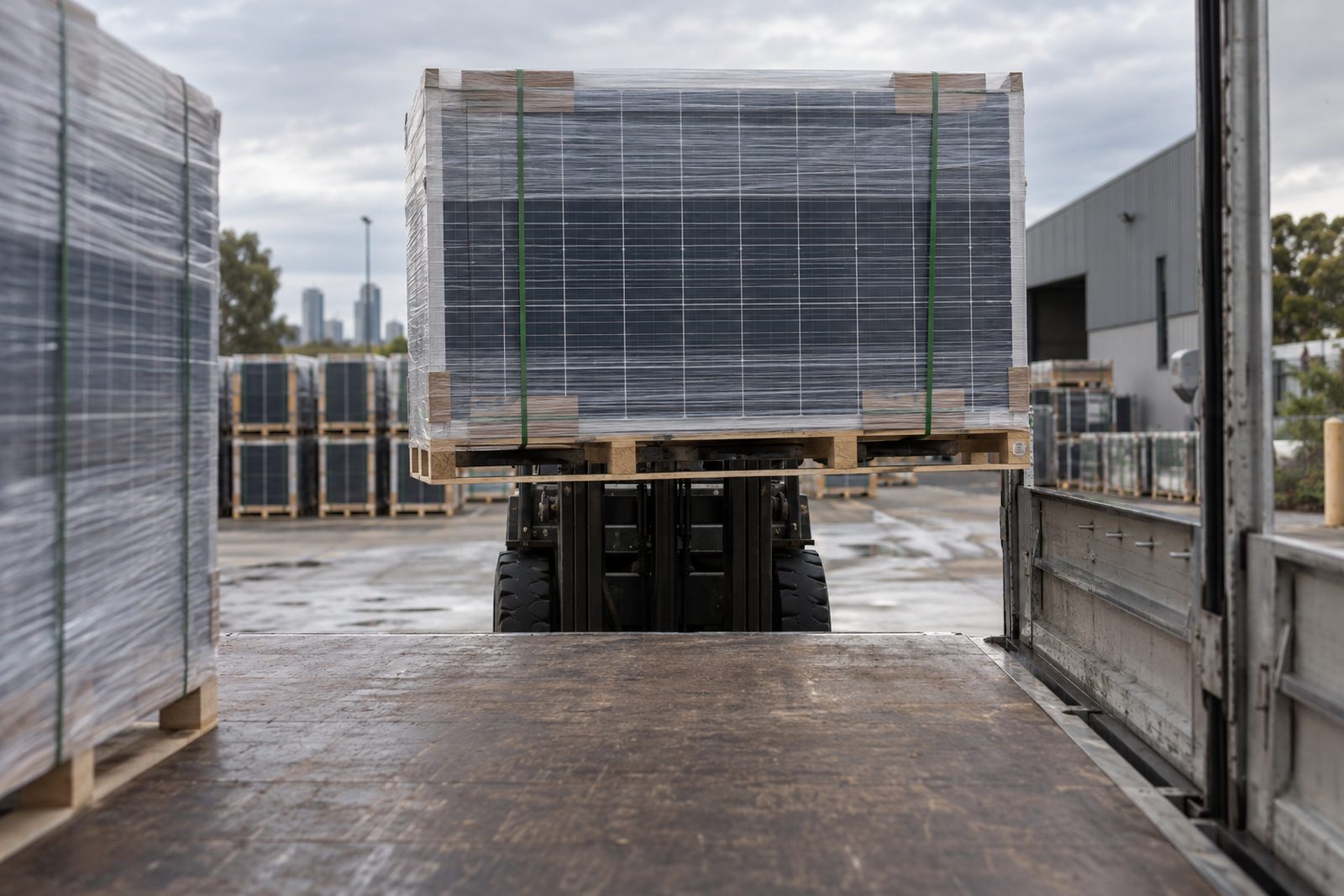 Pallets of solar panels lifted onto a truck